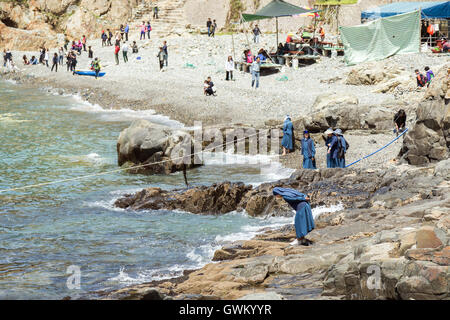 Nuns and other people at a pebble rock beach at the Taejongdae Resort Park in Busan, South Korea. Stock Photo