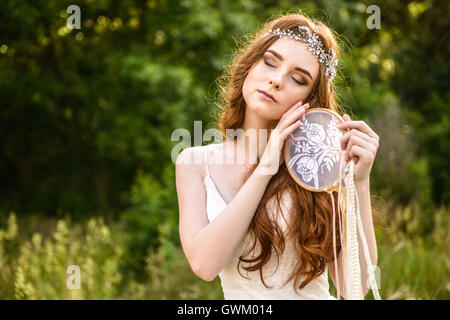 young redheaded girl smiling, Girl holding guardian, beautiful redheaded young girl, Girl holding dreamcatcher Stock Photo