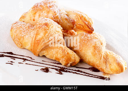 croissants on white plate isolated on the white background. Stock Photo