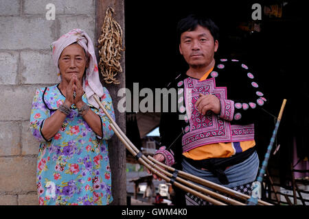 A member of Hmong Tribe with a traditional Kleng pipe organ in Mae Khi village in Mae Rim District, Chiang Mai, northern Thailand. Many Hmong people migrated from Laos to Thailand following the victory of the Pathet Lao in the late 1970s. While some ended up in refugee camps, others settled in mountainous areas becoming one of the ethnic groups referred to as Hill Tribes in Thailand Stock Photo