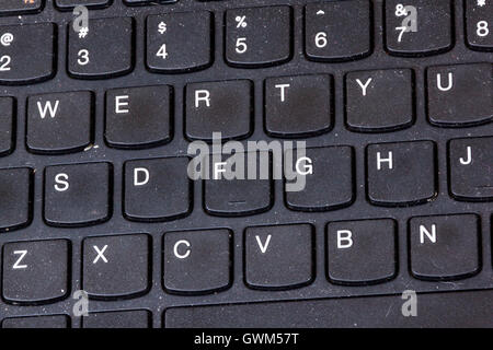 Close up of grimy black dirty dusty grungy neglected  laptop keyboard Stock Photo