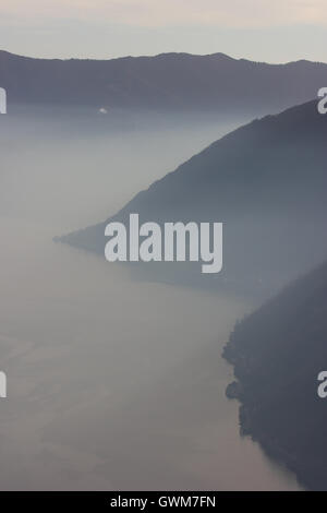 a beautiful misty monochrome picture of the lake and mountains, Italy Stock Photo