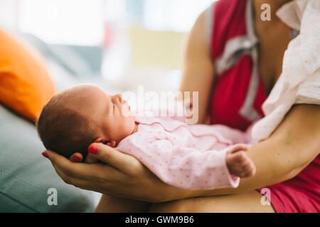 Mother holding  newborn with joy and pride Stock Photo