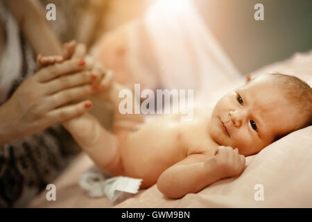 Parent changing beautiful newborn's diapers Stock Photo