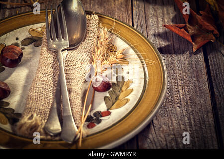Autumn place setting - on rustic wooden table Stock Photo