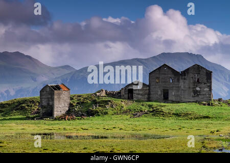 Ruins of a Deserted Farmstead set against the Mountains, West of Höfn, Southern Iceland Stock Photo