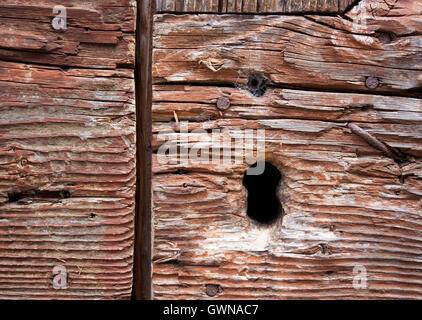 Keyhole on a wooden village door Stock Photo