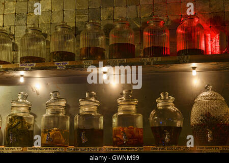 Jars of ya dong (Thai white spirits with medicinal herbs) at a bar in Bangkok, Thailand Stock Photo