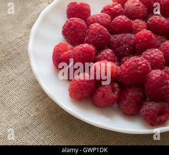 handful of fresh raspberries lying on a plate Stock Photo
