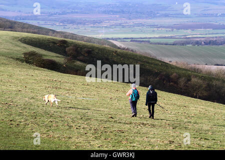 Women walking with dog near Firle Beacon, South Downs National Park, East Sussex, England, UK Stock Photo