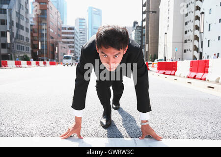 Young Japanese businessman ready to run Stock Photo