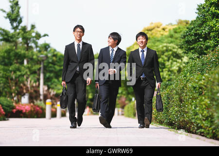 Young Japanese businessmen walking Stock Photo