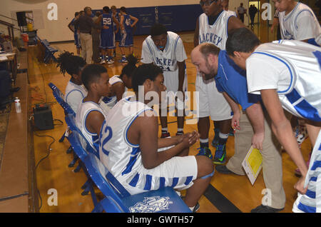 coach discusses strategy with a high school basketball game Stock Photo