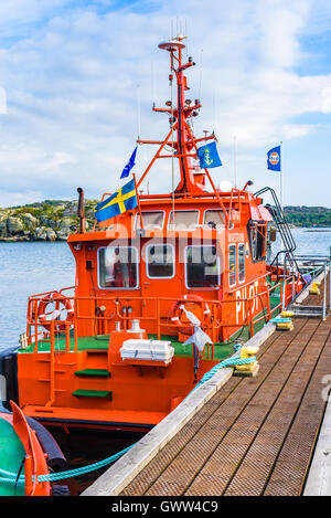 Marstrand, Sweden - September 8, 2016: Environmental documentary of red pilot boat moored in the harbor. Stock Photo