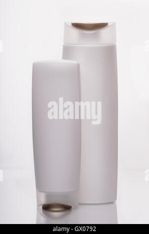 White bottles for liquids and shampoo in the bathroom, on a white background Stock Photo
