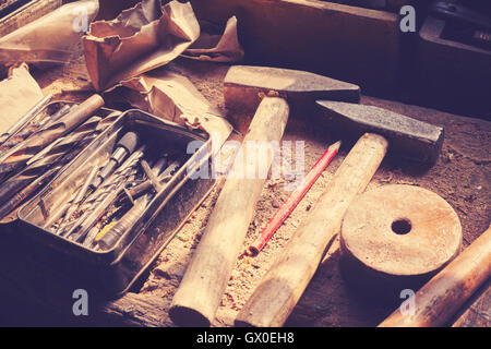 Retro toned old tools on dusty wooden table in a joinery. Stock Photo