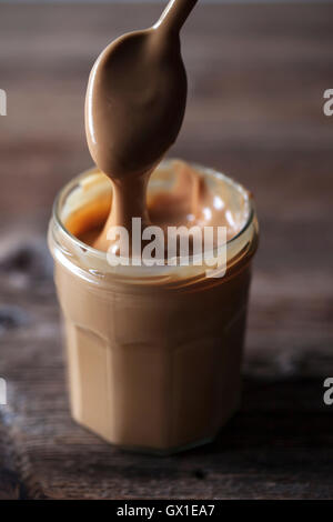 Natural homemade peanut butter in a glass jar Stock Photo