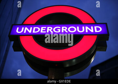A London Underground sign against the night sky outside St Paul's station, London. Stock Photo