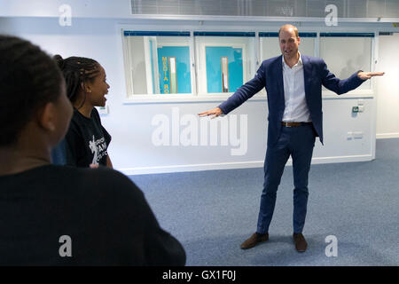 The Duke of Cambridge learns a dance move with Scariofunk dance collective during a visit to Caius House youth centre, London. Stock Photo