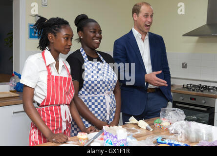 The Duke of Cambridge takes part in a baking class with young people and volunteers during a visit to Caius House youth centre, London. Stock Photo
