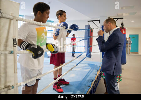 The Duke of Cambridge meets young people in a boxing ring during a visit to Caius House youth centre, London. Stock Photo