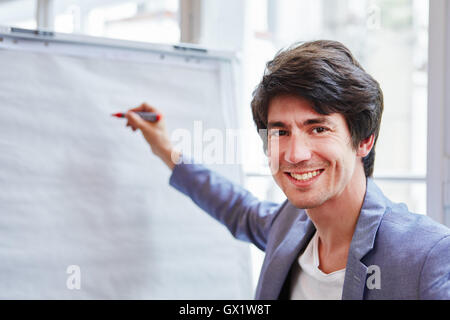 Successful businessman with pen in a presentation with whiteboard Stock Photo