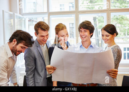 Start-up team happy with their successful project plan Stock Photo