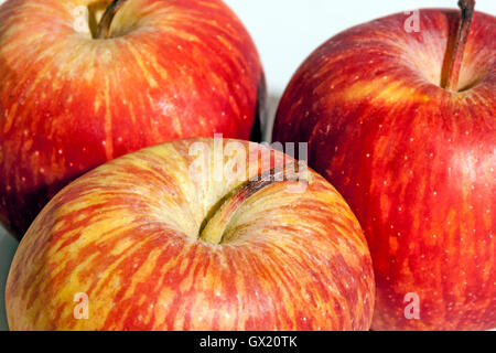 Extreme close up sections of three fresh red apples patterns and textures Stock Photo