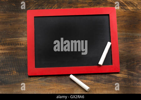 Empty Chalkboard wood frame with chalks and copy space. Stock Photo