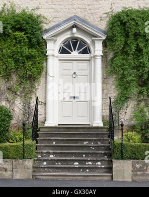 Elegant formal Georgian House Entrance with steps, side rails and plants. Stock Photo