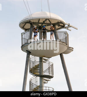 People at the top of the zip wire ride on the end of the pier preparing to descend, Bournemouth, Dorset, UK. Stock Photo