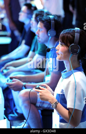 Thursday. 15th Sep, 2016. Visitors try to play videogames with Sony Interactive Entertainment's PlayStation 4 at the annual Tokyo Game Show in Chiba, suburban Tokyo on Thursday, September 15, 2016. The 20th anniversary Show includes show a new Virtual Reality (VR) area. The event hosts 614 exhibitors from 37 different countries and runs from September 15 to 18 at the International Convention Complex Makuhari Messe in Chiba. 1,523 game titles for smartphones, games consoles, PC and VR platforms are on show. Credit:  Yoshio Tsunoda/AFLO/Alamy Live News Stock Photo