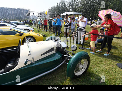 Beijing, China. 15th Sep, 2016. Visitors watch vintage cars during a vintage vehicle fair in Beijing, capital of China, Sept. 15, 2016. More than 100 vintage vehicles were displayed at the fair held in Beijing Olympic Forest Park Thursday. © Li He/Xinhua/Alamy Live News Stock Photo