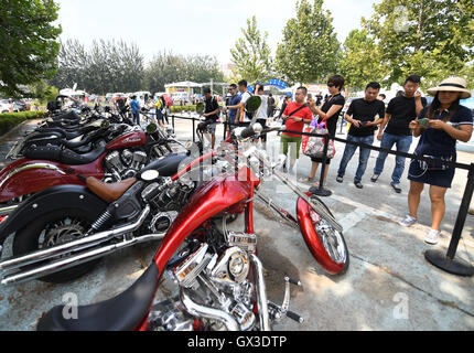 Beijing, China. 15th Sep, 2016. Visitors watch vintage vehicles during a vintage vehicle fair in Beijing, capital of China, Sept. 15, 2016. More than 100 vintage vehicles were displayed at the fair held in Beijing Olympic Forest Park Thursday. © Li He/Xinhua/Alamy Live News Stock Photo