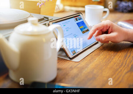 Business man works on tablet pc in cafe Stock Photo