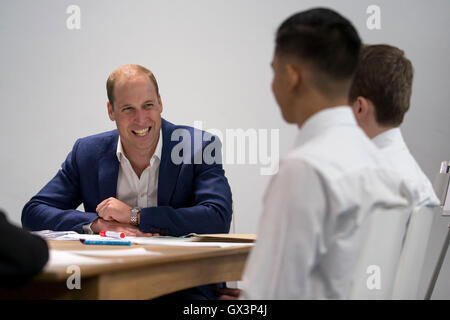 The Duke of Cambridge speaks with young people during a visit to Caius House youth centre, London. Stock Photo