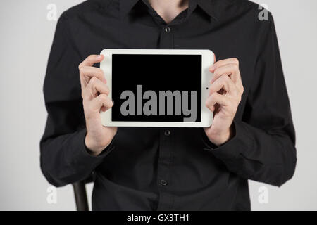 Business man holding and shows touch screen tablet pc Stock Photo