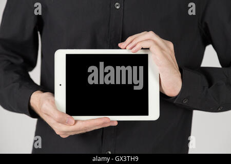 Business man holding and shows touch screen tablet pc Stock Photo