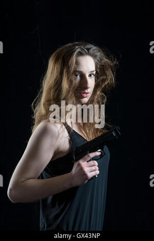 Woman holding a gun Stock Photo