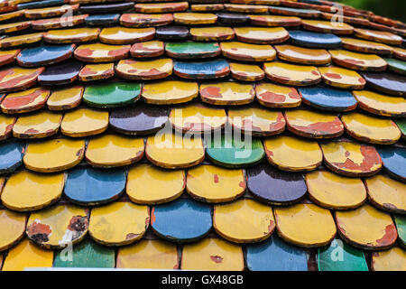 Colorful worn out round tiles with yellow green and blue colors. Stock Photo