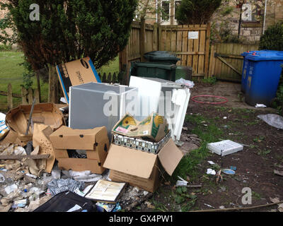 Household garbage refuse strewn in back lane, in Glasgow, Scotland ...