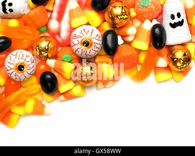 Halloween candy corner border over a white background Stock Photo