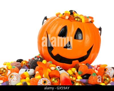 Halloween Jack o Lantern pail overflowing with candy Stock Photo