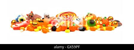 Long pile of colorful Halloween candy and sweets over a white background Stock Photo