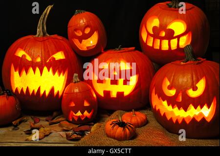 Halloween night scene with a group of spooky illuminated Jack o Lanterns Stock Photo