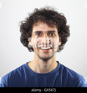 Happy young man in blue shirt smiling portrait. Stock Photo