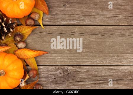 Natural fall side border of pumpkins and leaves. Top view on a rustic ...
