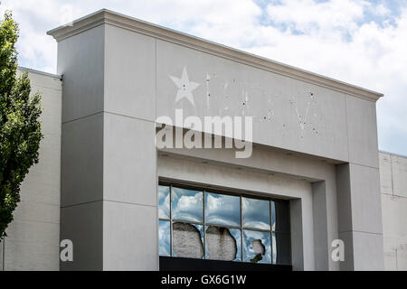 An outline of a logo sign outside of a closed Macy's retail store in Columbus, Ohio on July 23, 2016. Stock Photo