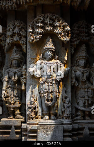 Deity sculpture under eves on shrine outer wall in the Chennakesava temple at Somanathapura, Karnataka,India,Asia Stock Photo