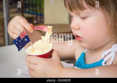 Young girl eating ice cream on Australia Day with Australian flag Stock Photo